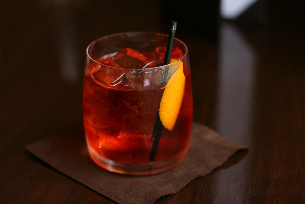 Red aperitivo-style drink with an orange slice
